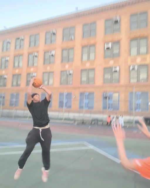 Basketball players moving across the court during a game.